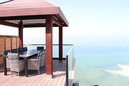 a gazebo on a deck next to the water at Lagoona Beach Luxury Resort and Spa in Manama