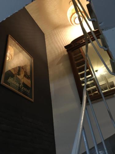 a sign on a wall next to a stair case at Chambres d’hôtes sur une île in Saint-Bonnet-de-Rochefort