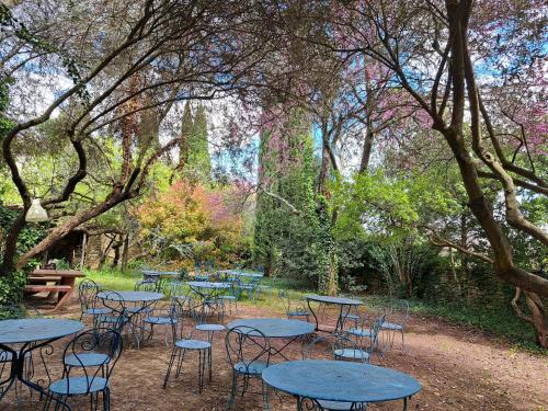 a group of tables and chairs in a park at Le Mas du Lac in Uzès