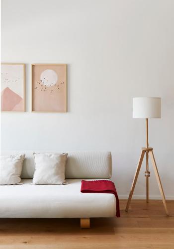 a white room with a couch and a lamp at La Sismonda in Rimini