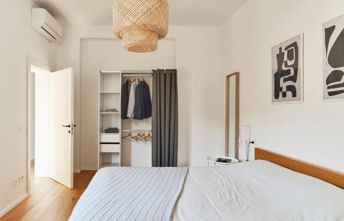 a bedroom with a white bed and a closet at La Sismonda in Rimini