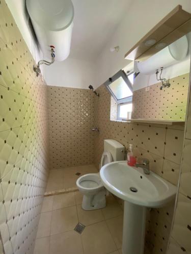 een badkamer met een toilet en een wastafel bij Selami GuestHouse in Peshkopi