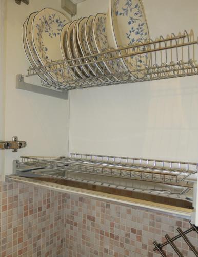 a shelf with plates and bowls on a wall at L'ONDA 2 - Portovener-Fezzano in Fezzano
