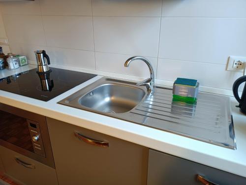 a kitchen with a sink and a counter top at Appartamento con giardino a Boccadasse in Genova