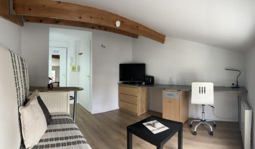 un salon avec un canapé et un bureau dans l'établissement A -15min à Vélo du vieux Port La Rochelle 2, à Aytré