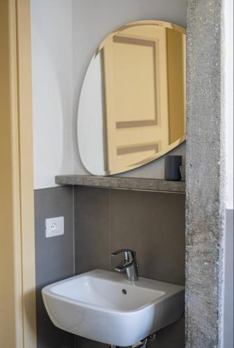 a bathroom with a white sink and a mirror at Villa Amanda in Scorcetoli
