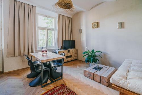 a living room with a table and a couch at Bohemian Experience in Prague