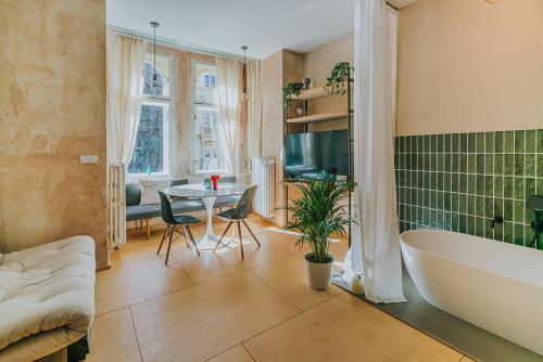 a bathroom with a tub and a table and a sink at Bohemian Experience in Prague
