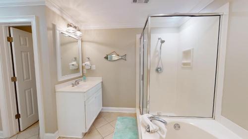 a bathroom with a shower and a sink at Brass Rail Villas 109 by Tybee Vacation Rentals in Tybee Island