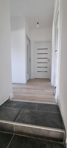 an empty room with white walls and a door at Infinity app 2024 in Beli Manastir
