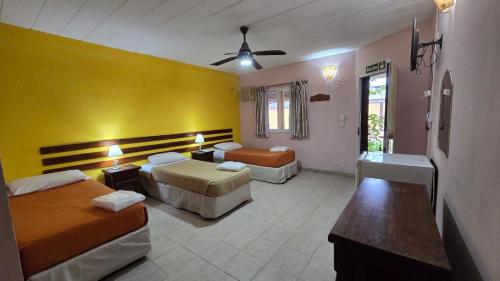 a hotel room with two beds and a bathroom at Villa Termal in Federación