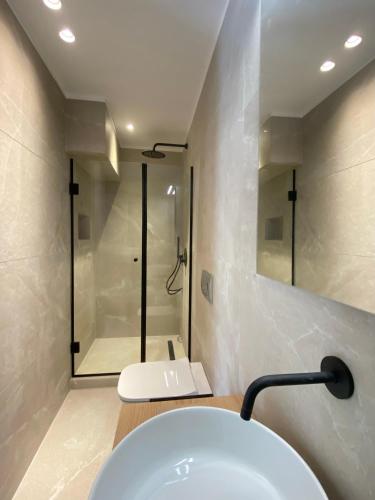 a bathroom with a white sink and a shower at Venice Studios & Apartments in Stavros