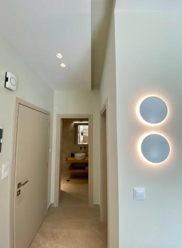 a hallway with two circular lights on the wall at Venice Studios & Apartments in Stavros