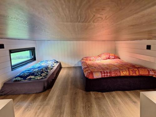 a bedroom with two beds in a tiny house at Microen in Stryn