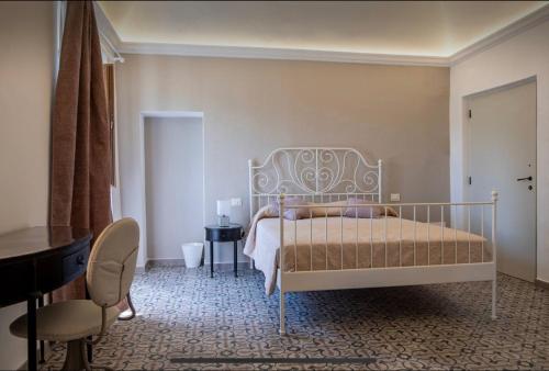 a bedroom with a bed and a table and a chair at Villa Amanda in Scorcetoli