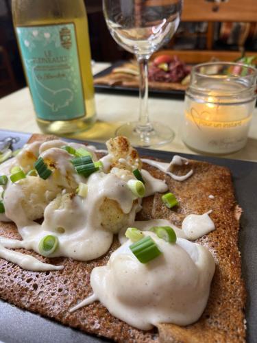 a plate of food with sour cream and green onions at Auberge musicale Pour un Instant in La Malbaie