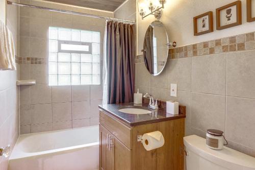 a bathroom with a sink and a tub and a toilet at Milwaukee Home with Serene Patio and Backyard Garden! in Milwaukee