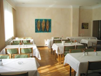 a dining room with white tables and chairs at Gildenhof An den Westfalenhallen Dortmund in Dortmund