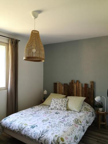 a bedroom with a bed with a comforter at Chambres d'Hôtes Domaine du Bourg in Gannay-sur-Loire