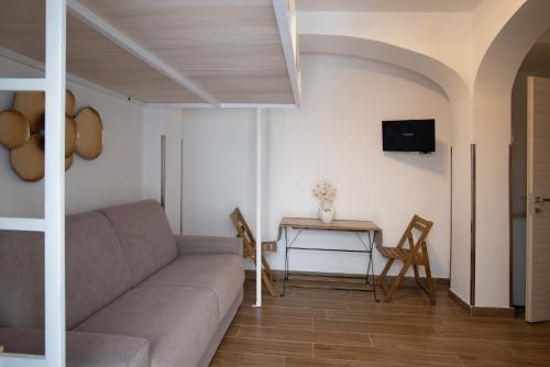 a living room with a couch and a table at Il Vicoletto sul Mare in Ischia