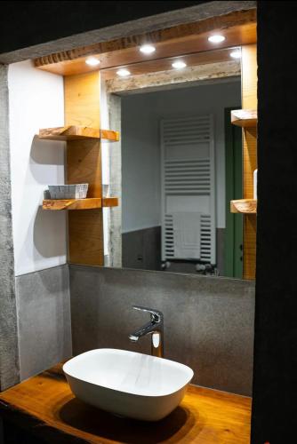a bathroom with a white sink and a mirror at Villa Amanda in Scorcetoli