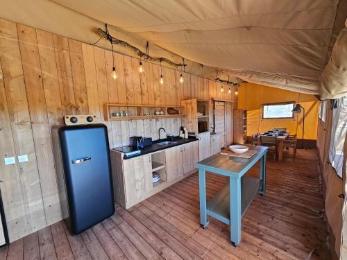 a kitchen in a tent with a table in it at Casa Boavista in São Martinho do Porto