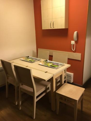 une table de salle à manger et des chaises dans une pièce dans l'établissement Joli meublé T2 au Cap Esterel vue Esterel et mer, à Agay