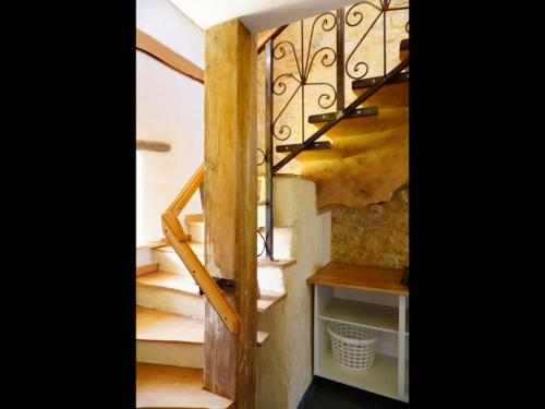 a staircase in a house with a metal railing at Ty Oliv- entre terre et ocean in Plonéour-Lanvern
