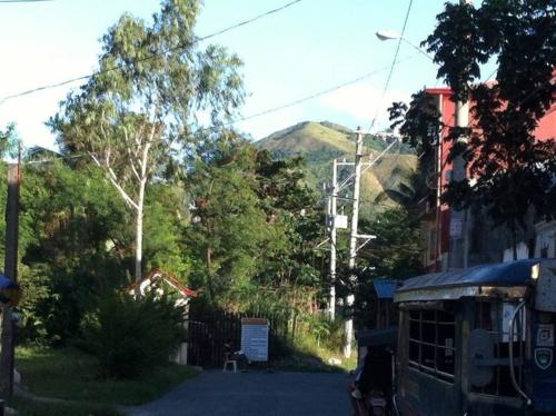 a street with trees and mountains in the background at 7pax, 2 AC BR,Videoke,Games,Netflix,Cook,Parking in Rodriguez