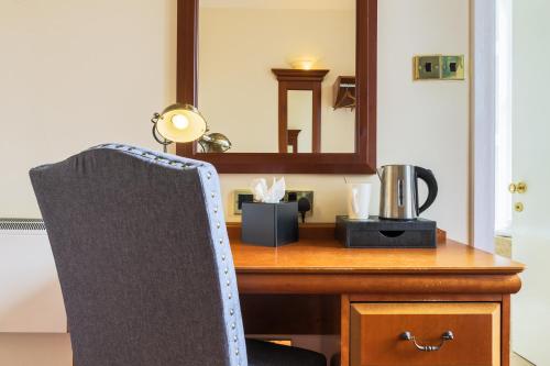 a desk with a chair in front of a mirror at Old Waverley Hotel in Edinburgh