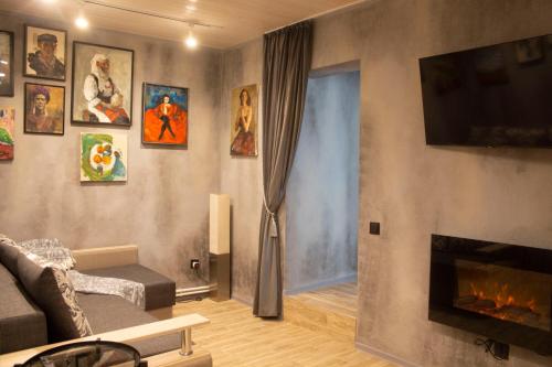 a living room with a couch and a fireplace at City center Artmania apartments in Chişinău
