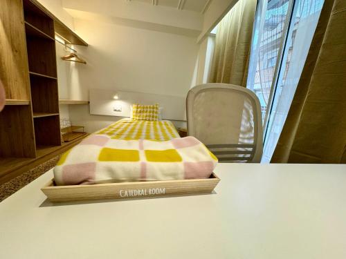 a bed sitting on a table in a room at Guest House Espinardo Casa Universitaria in Espinardo