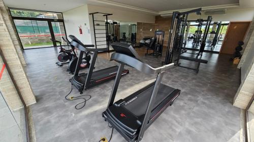 a gym with several tread machines in a room at Resort QSB - Um novo padrão de conforto e lazer no coração da cidade in Pirenópolis