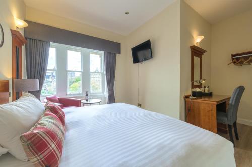 a hotel room with a bed and a window at Old Waverley Hotel in Edinburgh