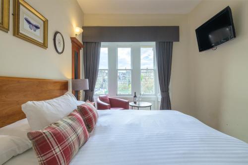 a hotel room with a bed and a window at Old Waverley Hotel in Edinburgh