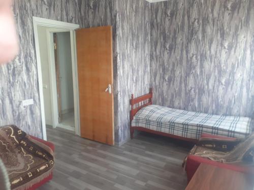 a bedroom with two beds and a sliding door at Sevan Writers House in Sevan