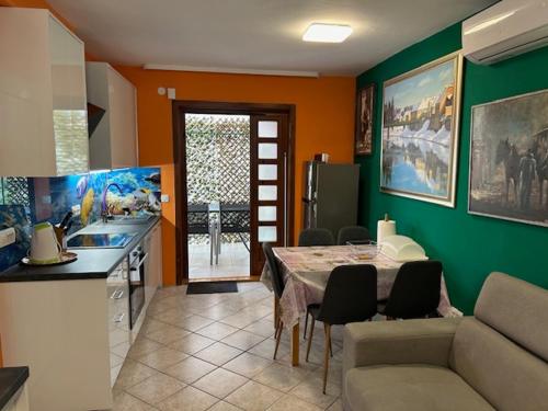 a kitchen and dining room with a table and chairs at CALYPSO in Biograd na Moru
