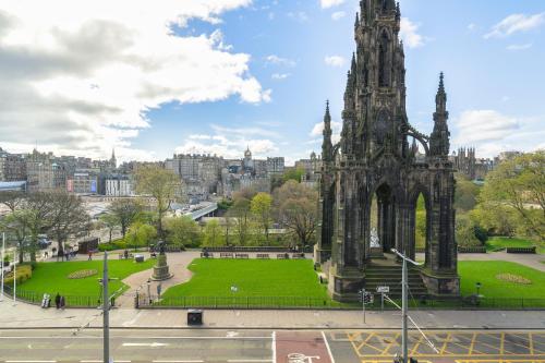 a large monument in a park with a green park at Old Waverley Hotel in Edinburgh