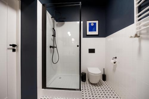 a bathroom with a shower and a toilet at Art Apartment in Toruń