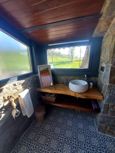 a bathroom with a sink and a window at Mas Can Cels in Sant Pau de Segúries