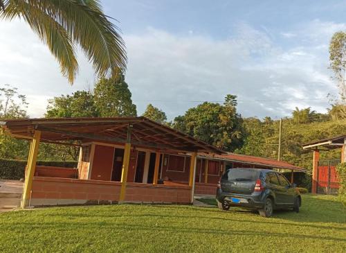 a car parked in front of a house at La tina in Yolombó