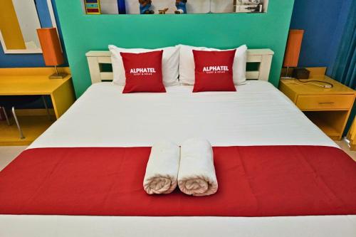 a bedroom with a bed with two towels on it at Phu Jaya Floresta Resort by ALPHATEL PARTNER in Chiang Mai