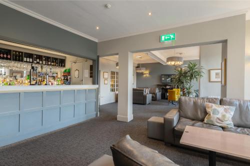 a living room with a bar and a couch at Old Waverley Hotel in Edinburgh