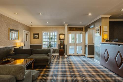 a living room with a couch and a table at Old Waverley Hotel in Edinburgh