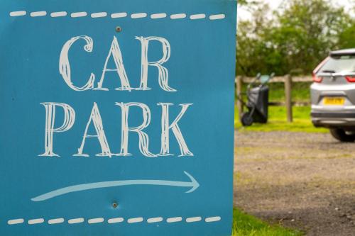 a sign for a car park in a parking lot at Kestrel - Sweffling Hall in Rendham