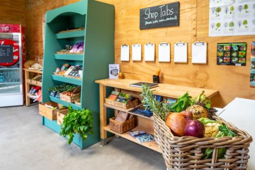 a produce section of a store with baskets of vegetables at Kestrel - Sweffling Hall in Rendham