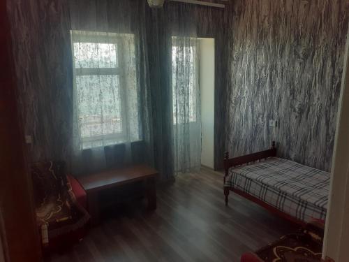 a bedroom with a bed and a window at Sevan Writers House in Sevan