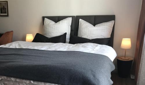 a bedroom with a large bed with four pillows at Sonnenbalkon in Bad Elster