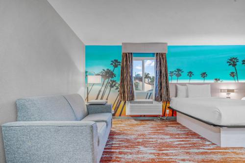 a living room with a bed and a couch at Avania Inn of Santa Barbara in Santa Barbara