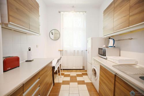 a kitchen with a white refrigerator and a washing machine at Sunny by 3City Rentals in Sopot